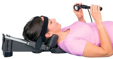 Woman using the Saunders Cervical Traction Device